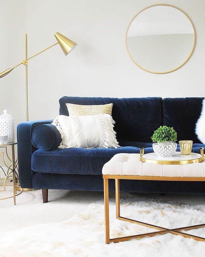 simple white living room blue couch gold accents