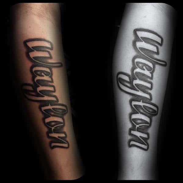 negative space lettering kids name outer forearm tattoo for men