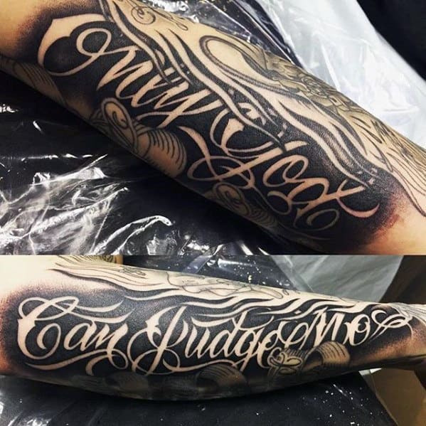 negative space lettering only god can judge me mens forearm tattoo