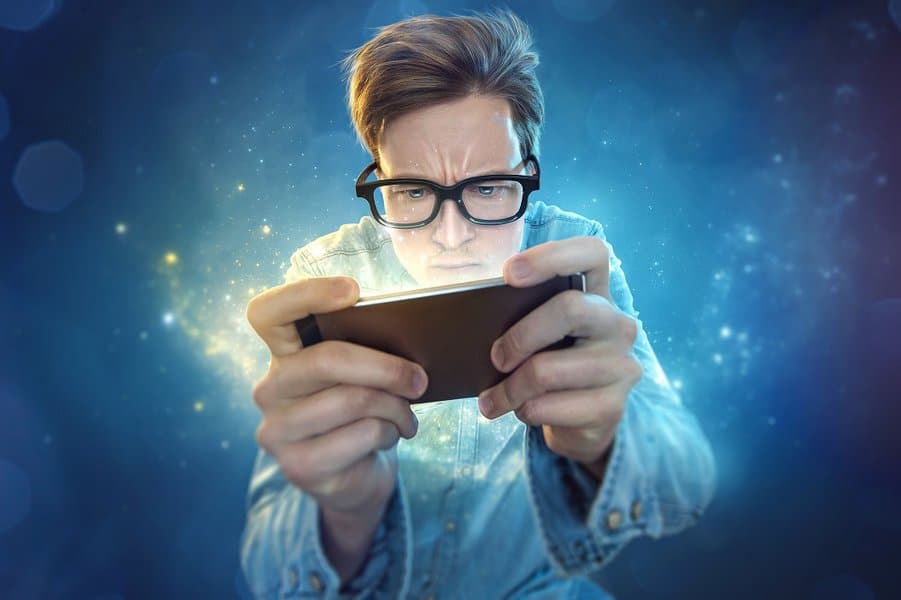 nerd man playing games on mobile phone