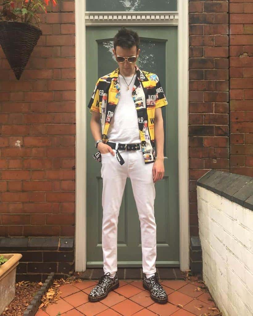 white under printed polo and white pants with cool shades
