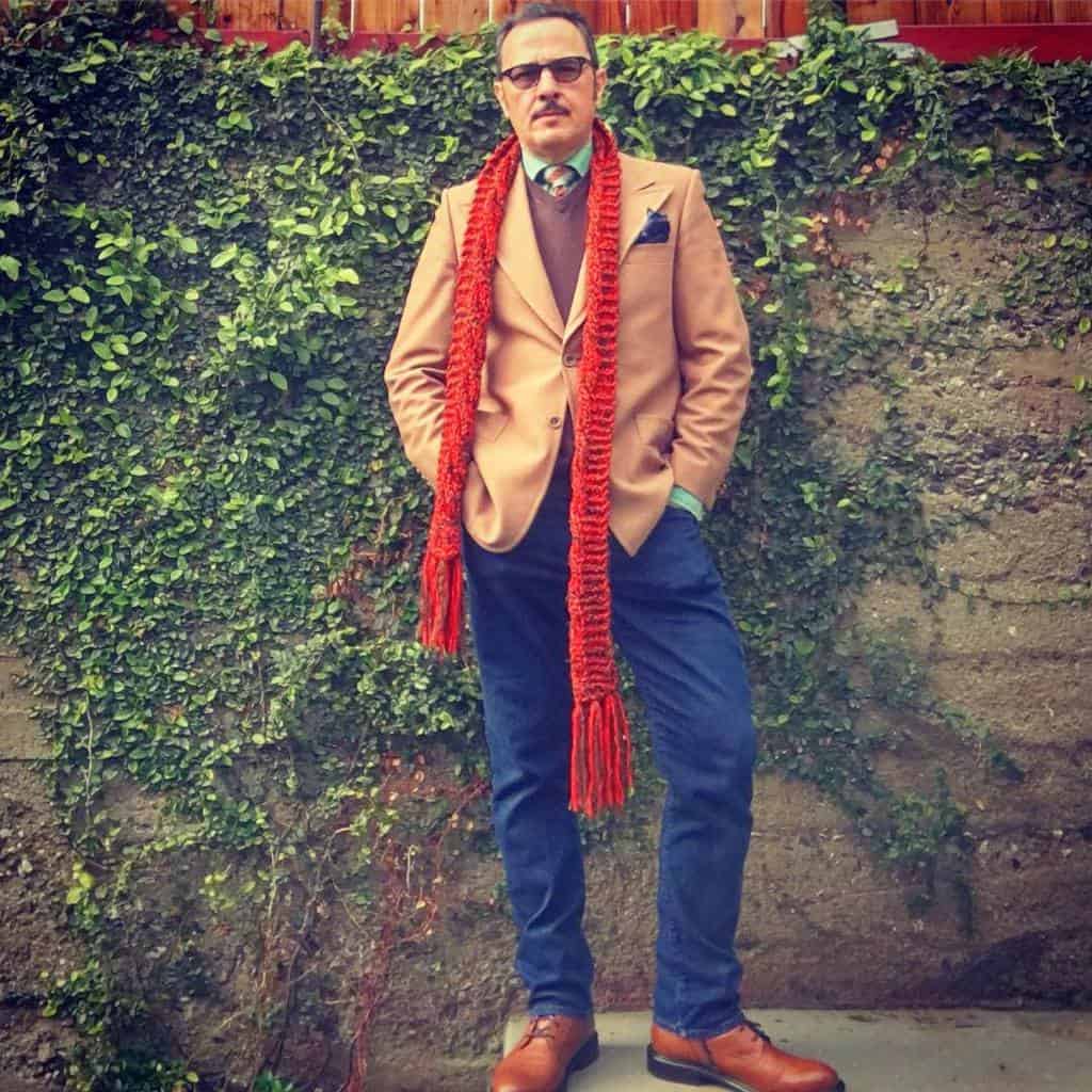 brown coat under nice shirt and denim pants with orange scarf and cool shades