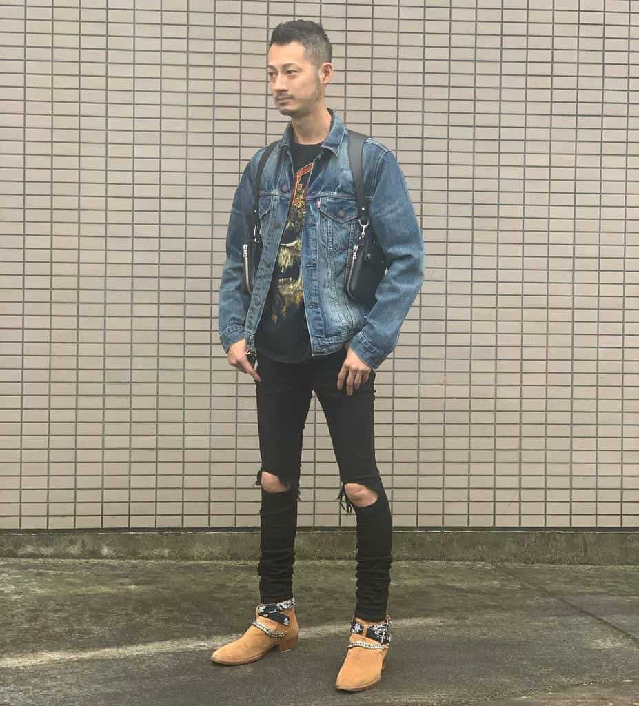 denim jacket under is black printed shirt with ripped jeans and cool shoes