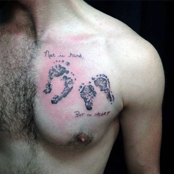Not In Hand But In Heart Footprint Male Upper Chest Tattoos
