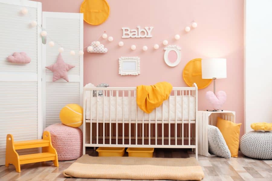 pink nursery white crib and wall divider