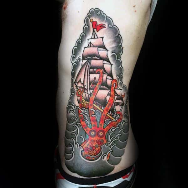 Old School Guys Ribcage Tattoo Of Kraken With Tentatcles Wrapped Around Sailing Ship At Sea