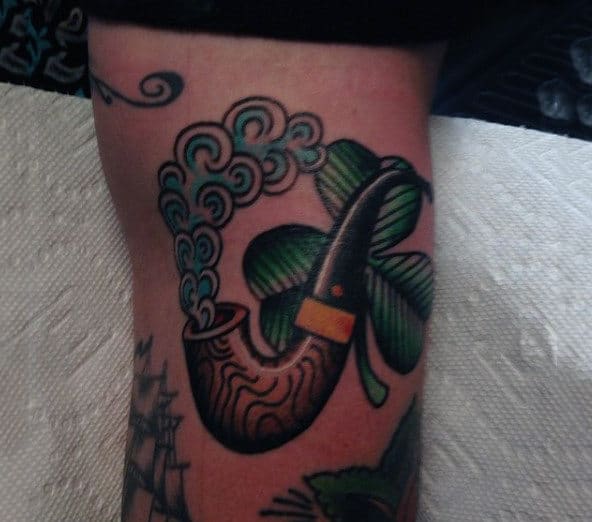 Old School Shamrock And Smoking Pipe Male Arm Tattoo