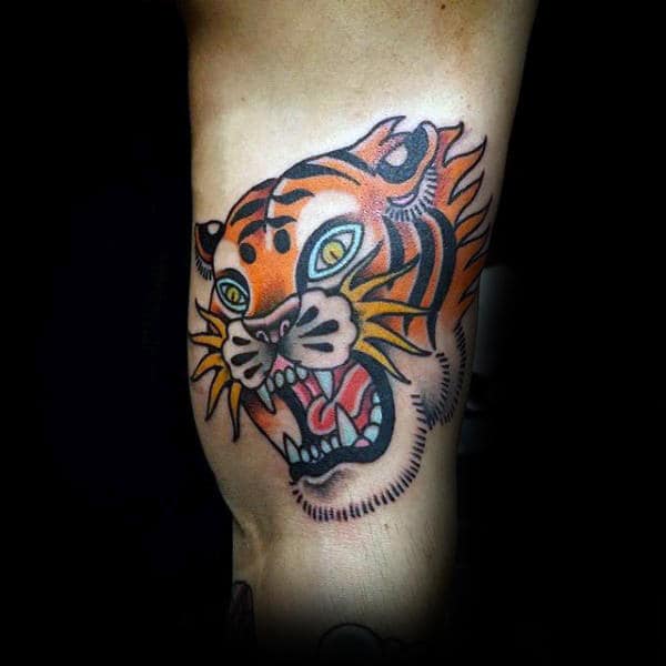 Orange Growling Traditional Tattoo Of Tiger On Guys Arm