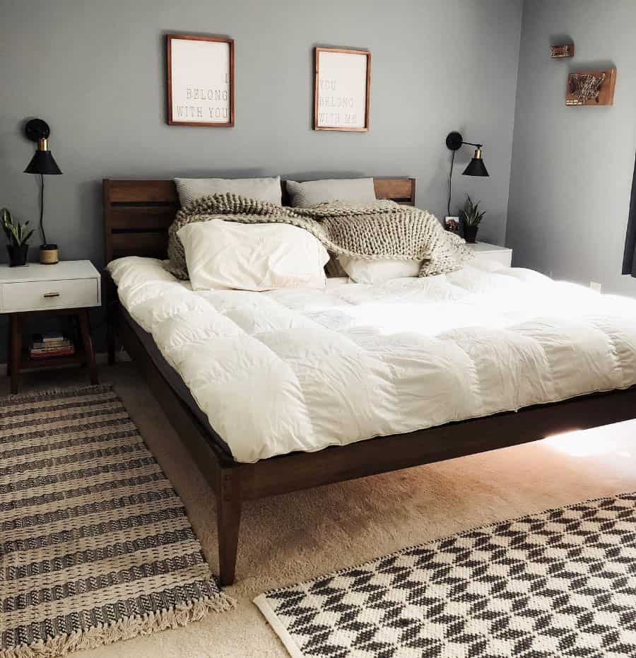 Rustic bedroom with wooden bed frame, cozy blankets, and geometric rugs.