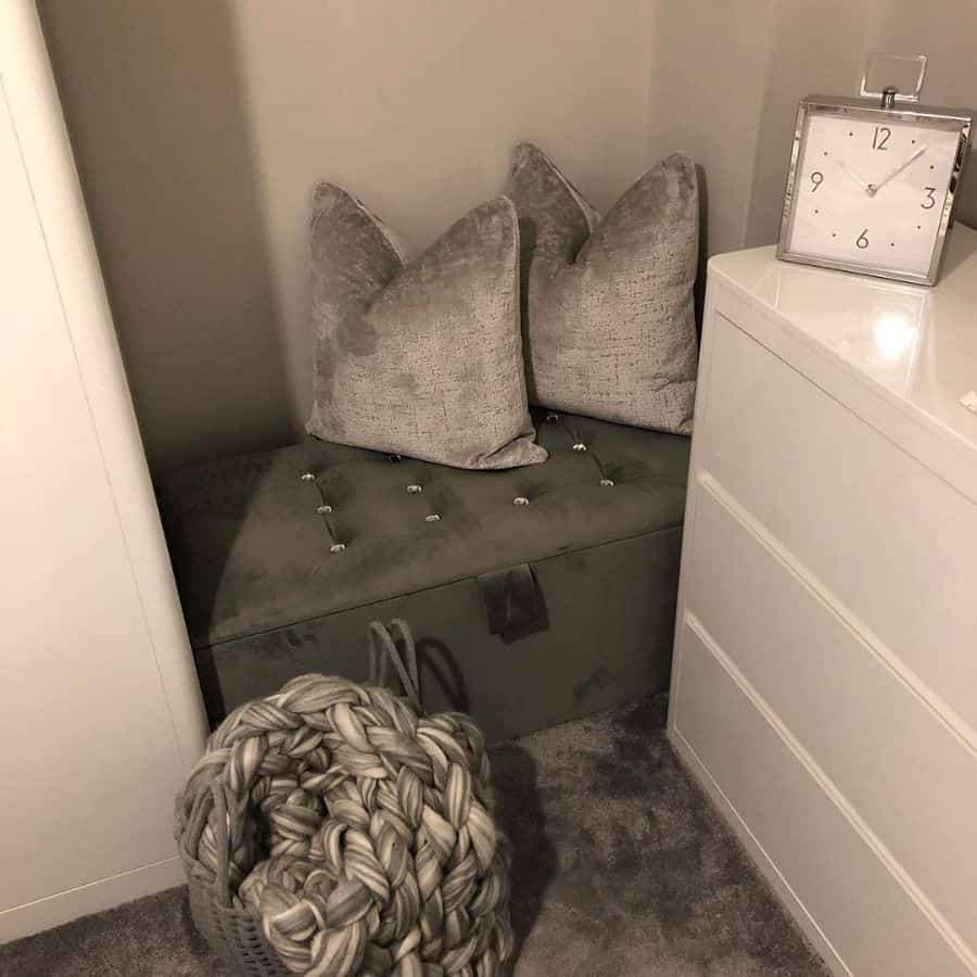 gray ottoman and pillows