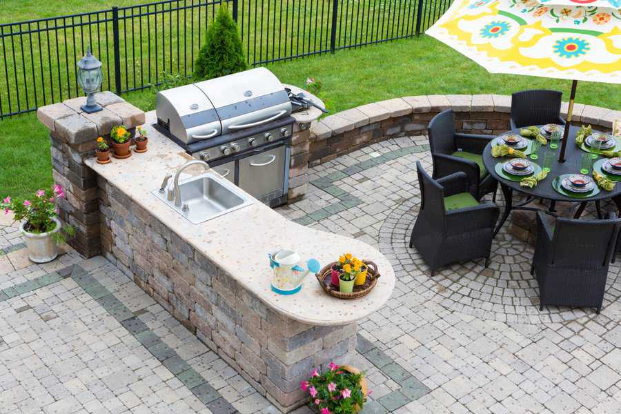 stylish outdoor kitchen with bbq sink and bar area