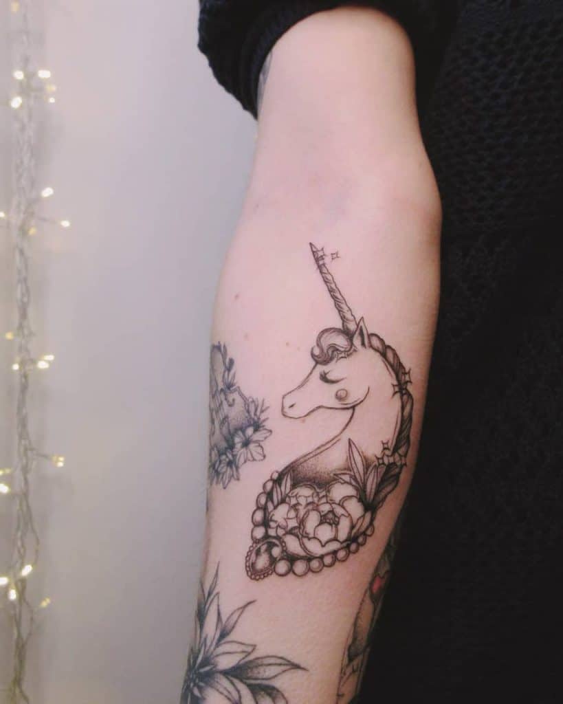 Outer Forearm Black And Gray Tasteful Delictae Cartoon Unicorn Tattoo