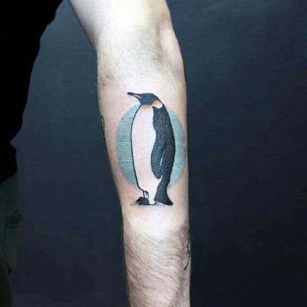 Outer Forearm Penguin With Blue Circle Background Tattoo For Guys