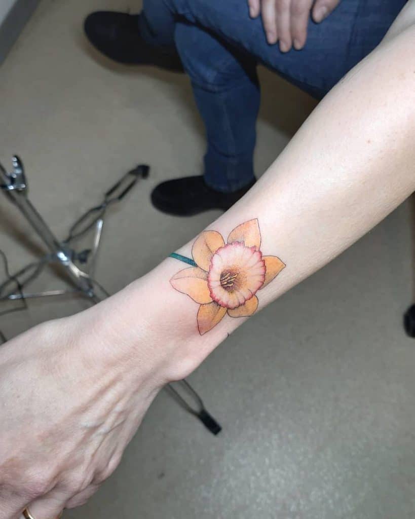 Outer Left Wrist Single Orange Daffodil Color Tattoo
