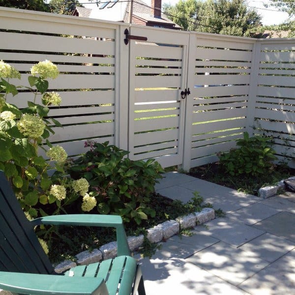 white backyard fence with gate 