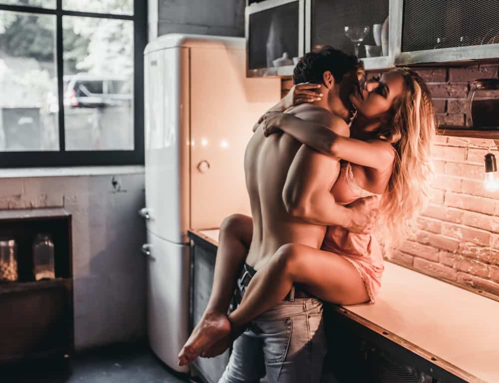 passionate couple having sex on kitchen