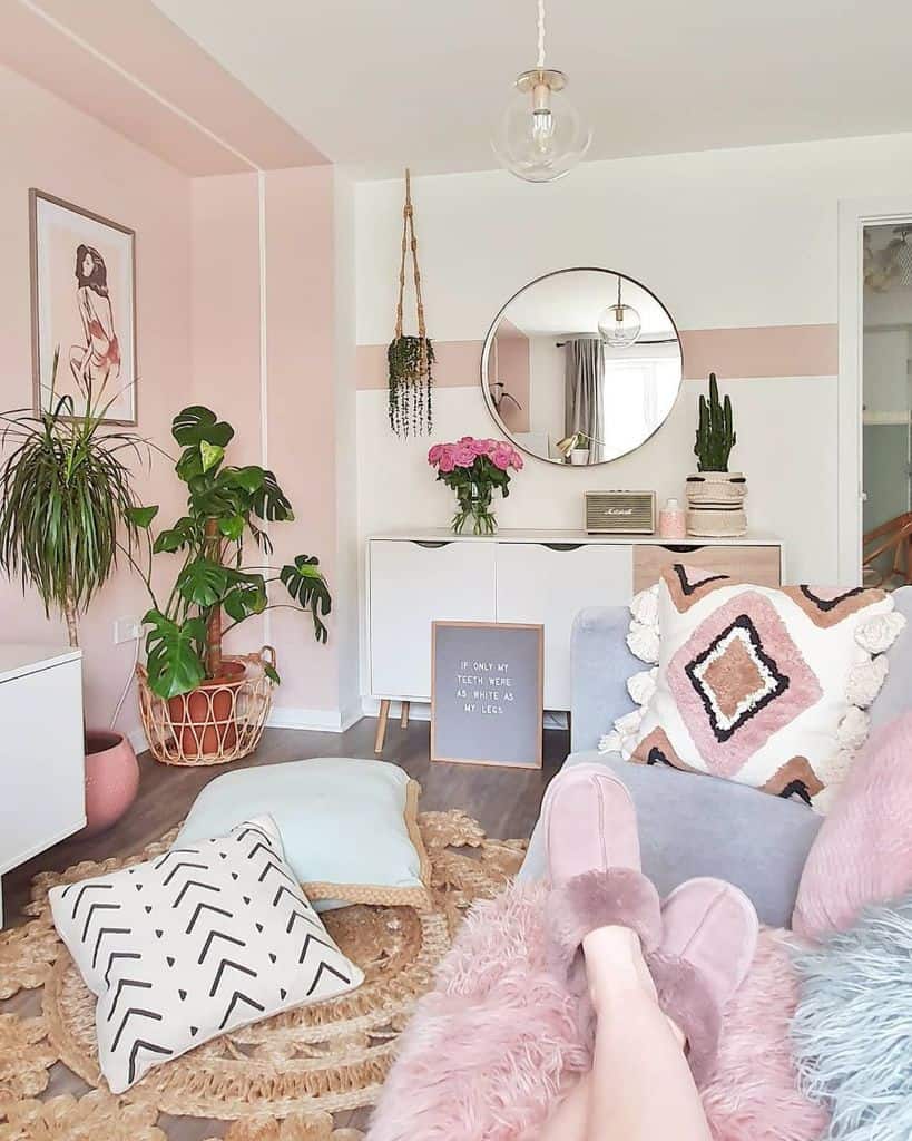 pink inspired pastel living room with house plants and wall mirror 