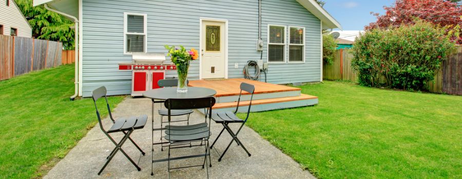 backyard cement patio with table and chairs 