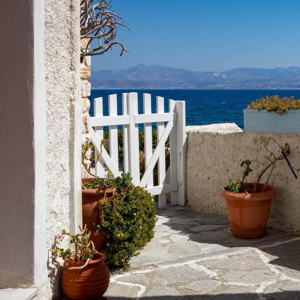 white picket gate mediterranean home ocean view