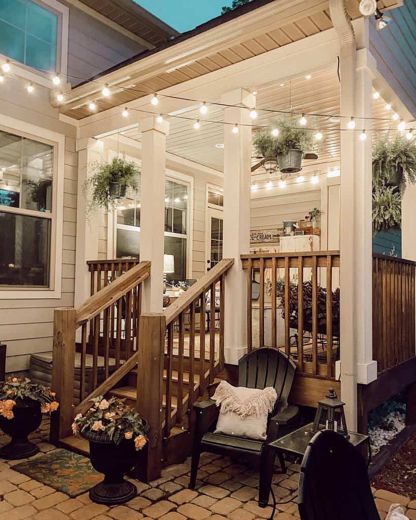 farmhouse front porch deck with sting lights and hanging plants 