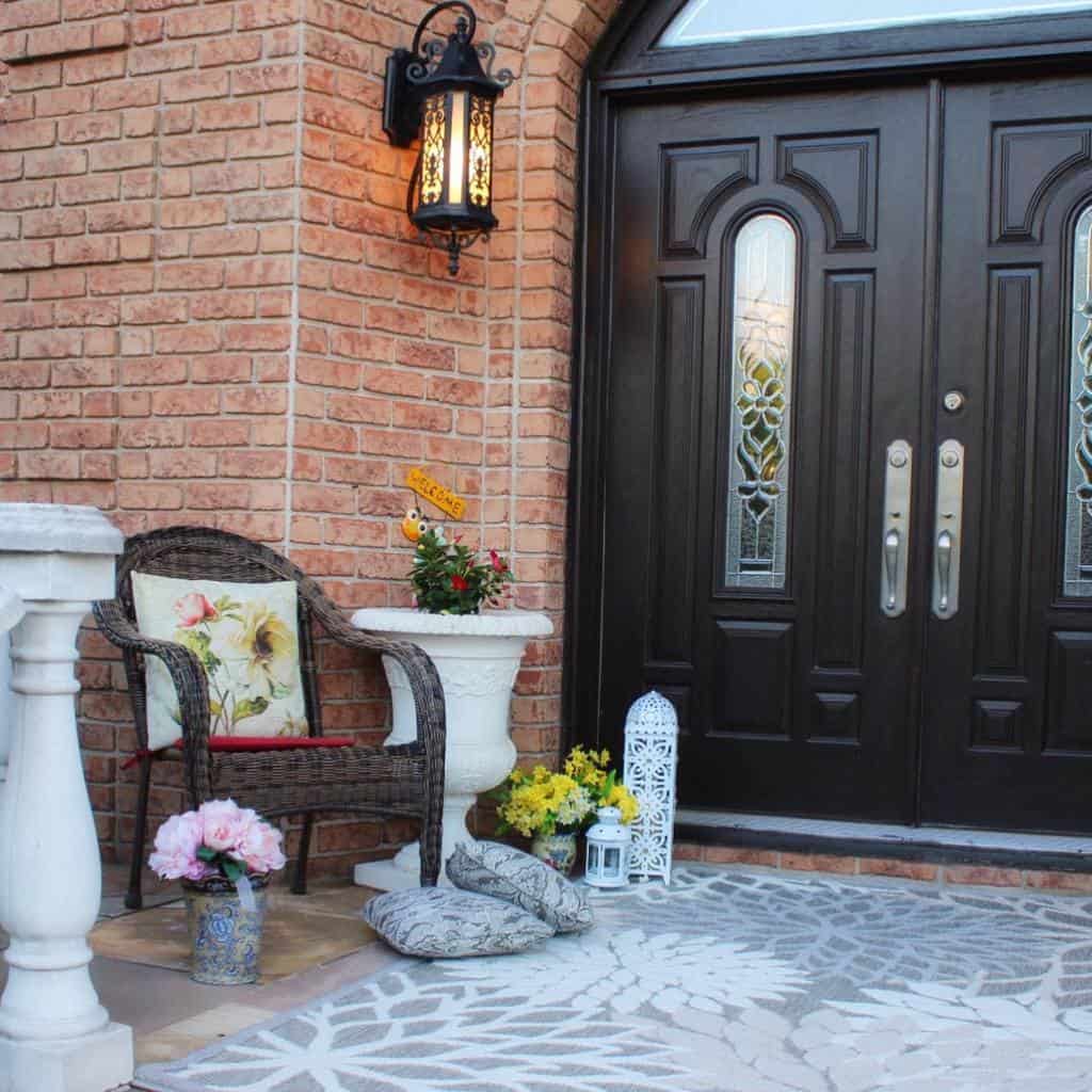 front porch with wicker chair and flowers 