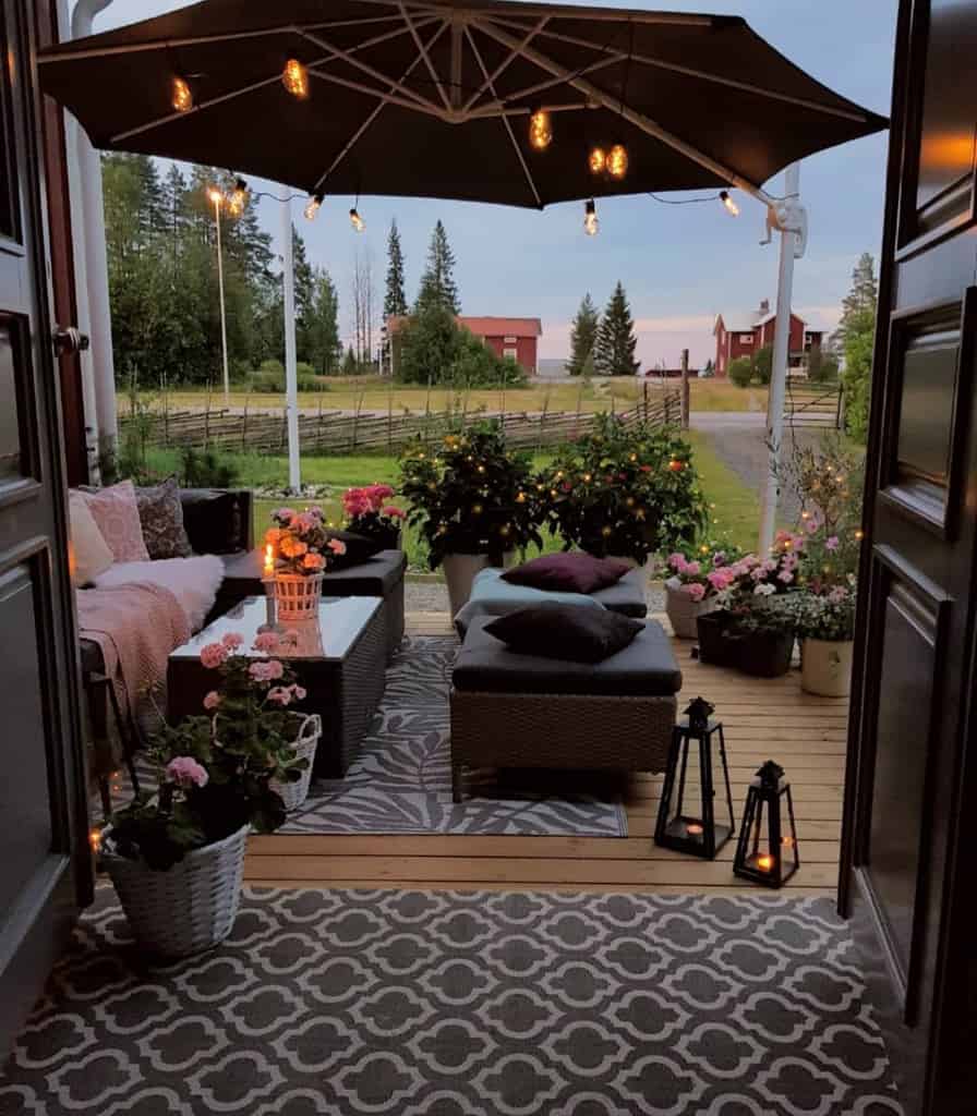 modern porch wood deck with umbrella and string lights