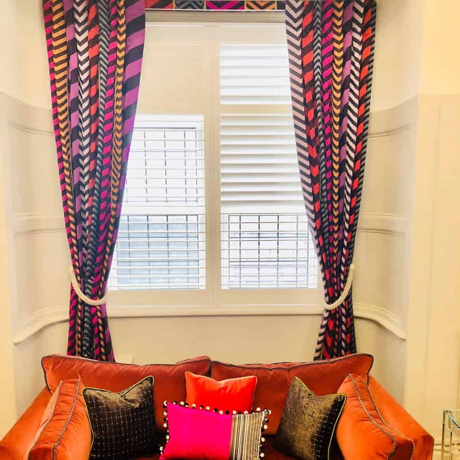 colorful pattern curtains orange couch 