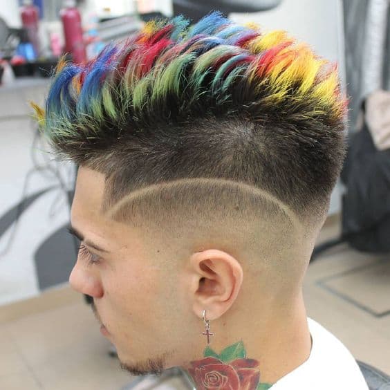 A frohawk haircut for men featuring faded sides and rainbow shades on the strip of hair on top