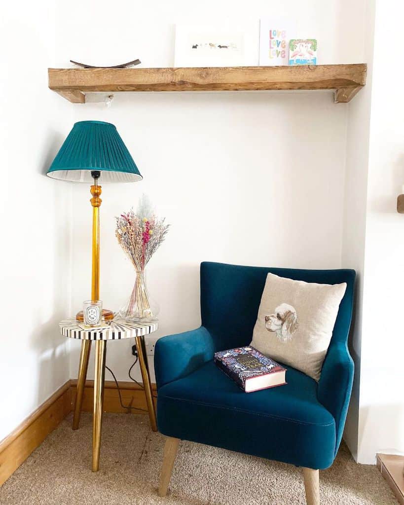 comfortable reading corner nook with blue armchair 