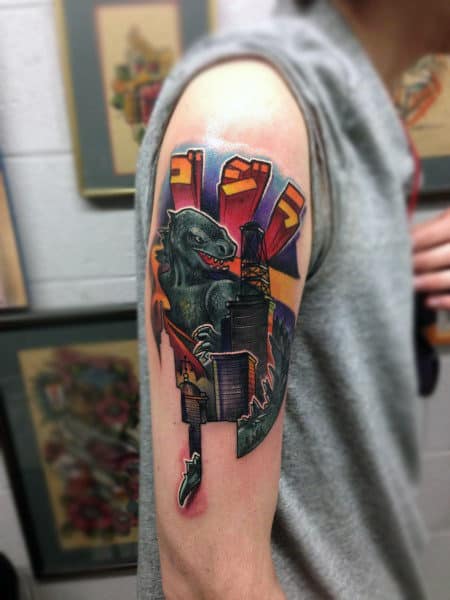 Realistic Graphic Tattoo With Color Of Godzilla On Mans Bicep