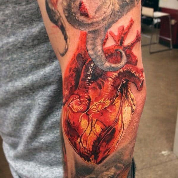 Realistic Male Heart Tattoo Design On Outer Arm