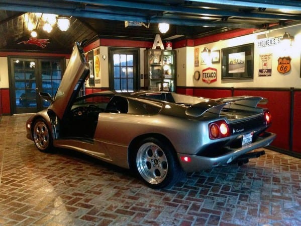red and white wall garage silver sports car paved floor