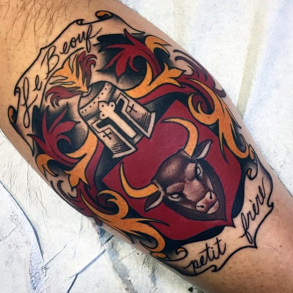 Red And Yellow Family Crest Tattoo With Bull For Men On Leg