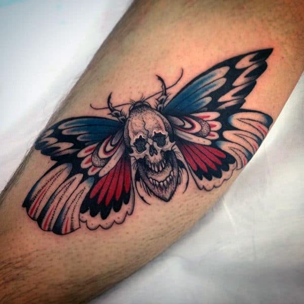 Red Black And Blue Male Moth With Skull Leg Tattoos