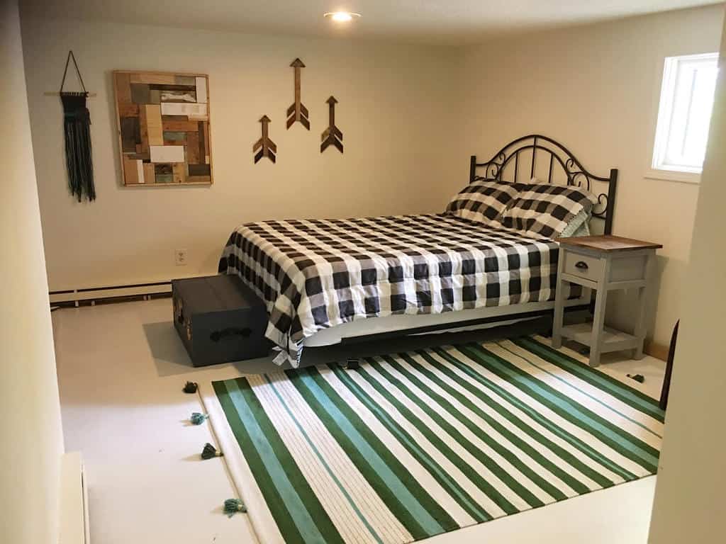 small remodel basement with double bed and chest 