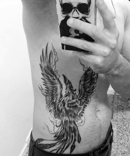 Rib Cage Side Man With Tattoo Of A Phoenix