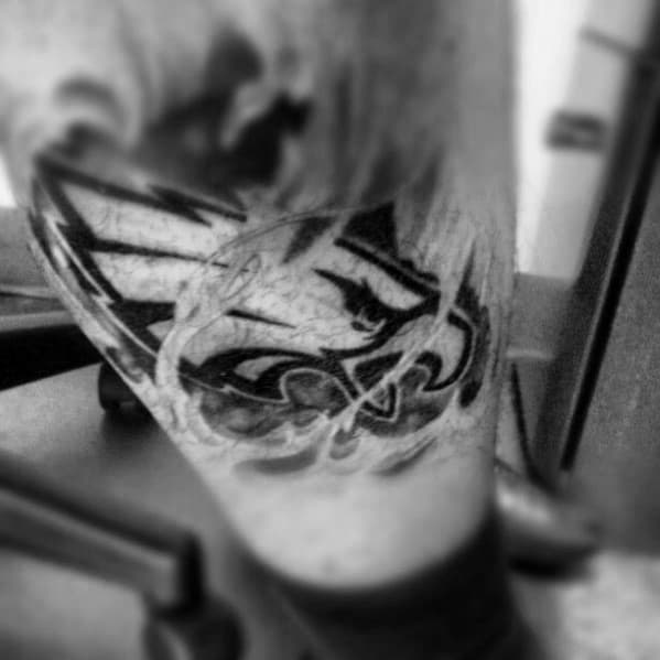 Ripped Skin Shaded Male Philiadephia Eagles Lower Leg Tattoo Design Ideas