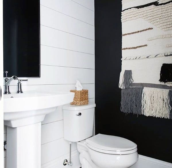 black and white bathroom with wall rug