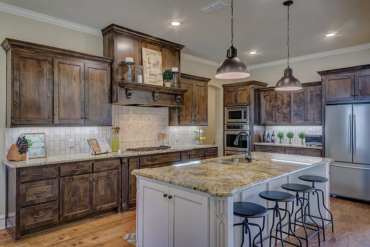 rustic farmhouse kitchen hardwood floor wood cabinets black stools