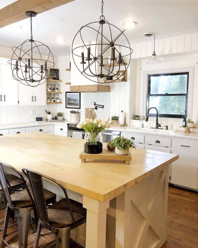 white rustic farmhouse kitchen with black accents wood island with black chairs