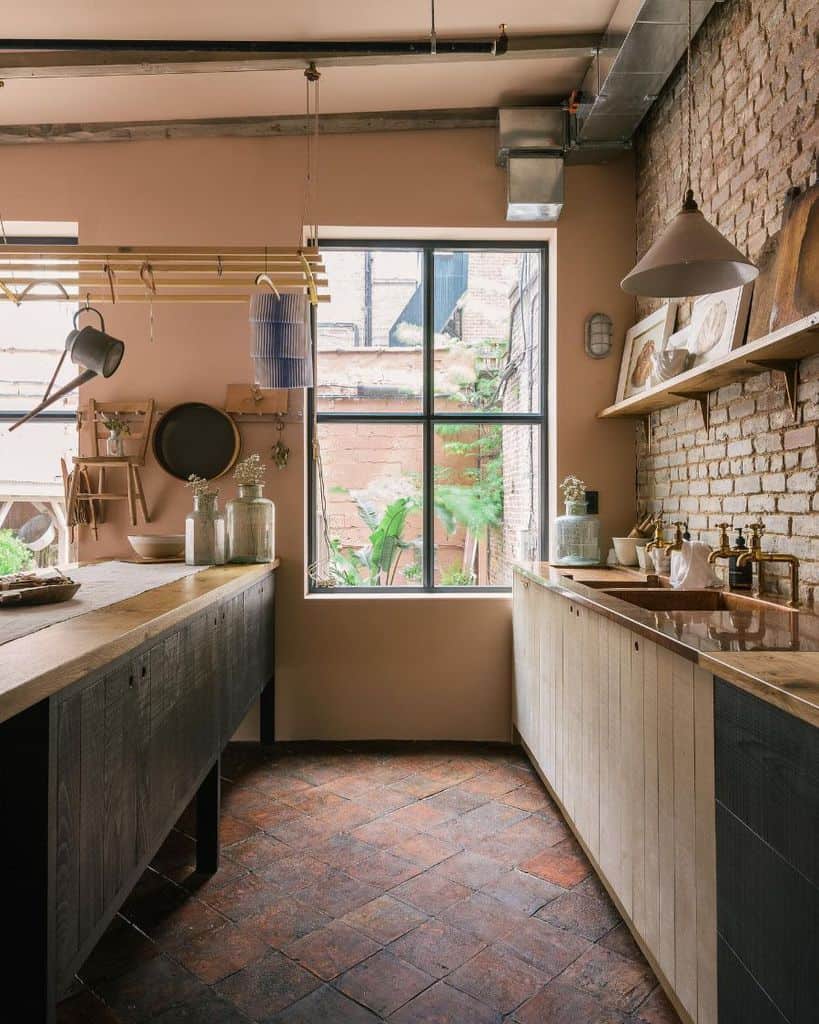 rustic galley kitchen feature brick wall paved floors pink walls wood cabinets 