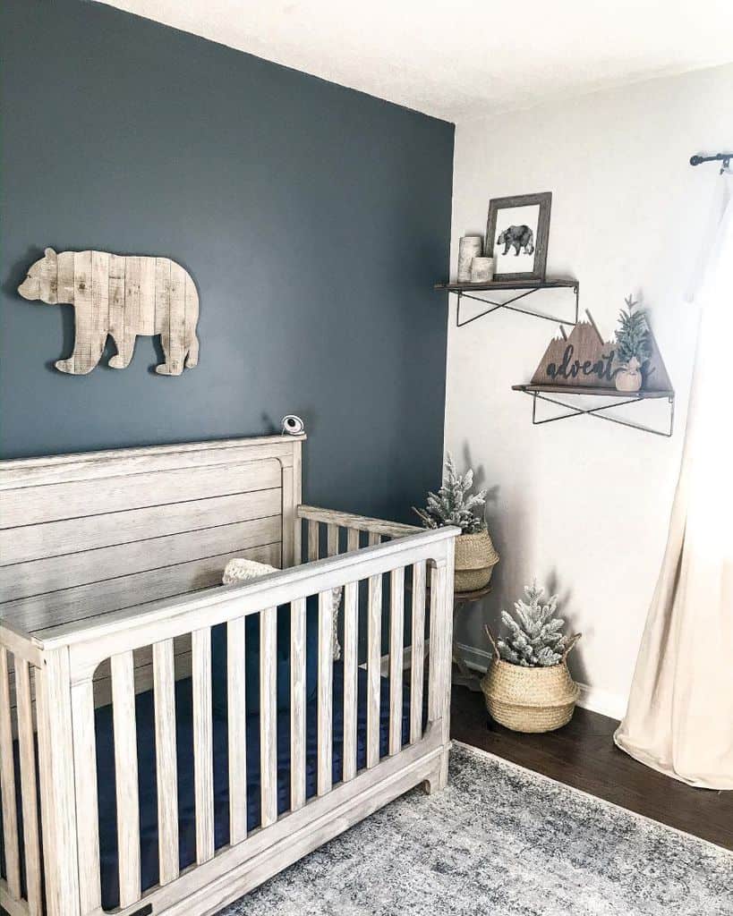 rustic nursery blue accent wall white wood crib wicker plants wall shelves 