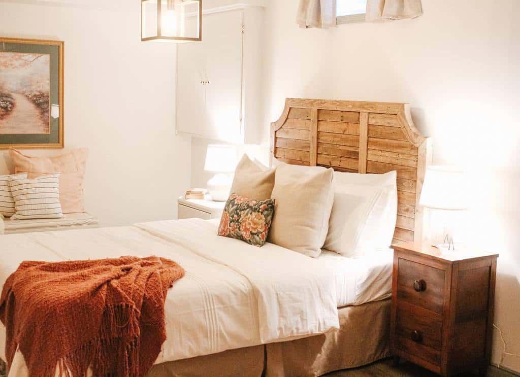 rustic small basement bedroom with wood headboard bed