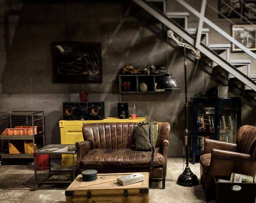 rustic masculine small basement living with brown leather sofas 