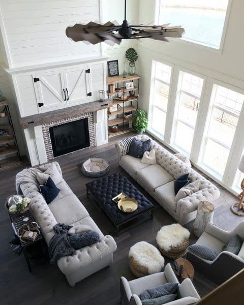 above view of luxury living room with fireplace and gray sofas 