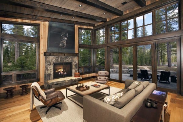 rustic cabin style living room stone fireplace floor to ceiling walls couch