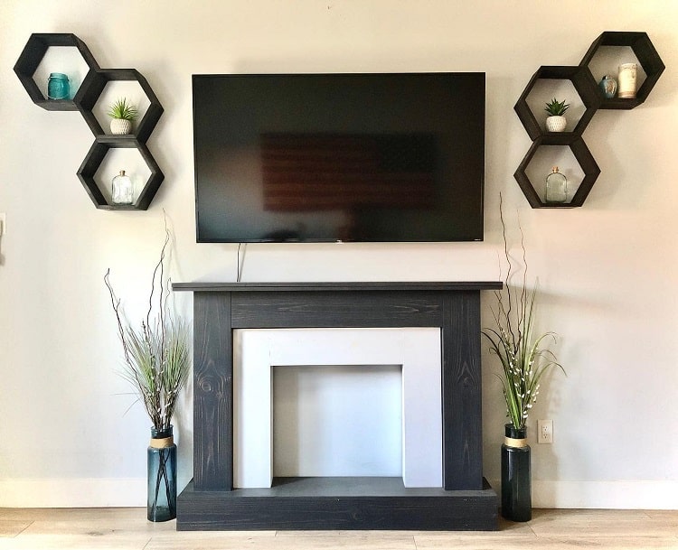 rustic woodwork faux fireplace surround hexagonal wall shelves mounted tv