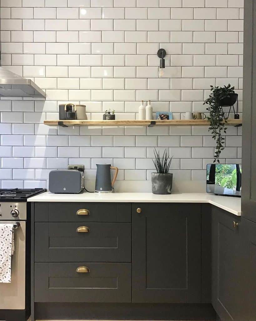 white tile wall kitchen black cabinets 