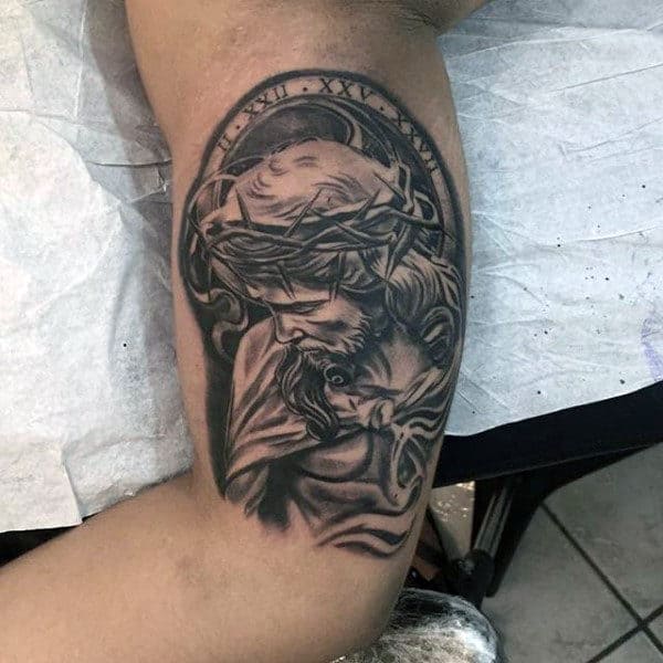 Shaded Black And Grey Ink Jesus Tattoo Designs For Men On Bicep Of Arm