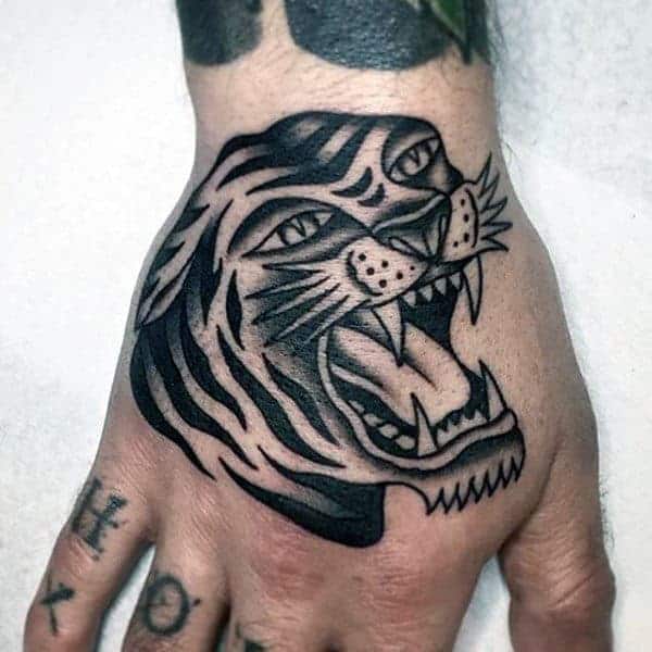 shaded-black-and-grey-ink-male-traditional-tiger-hand-tattoos